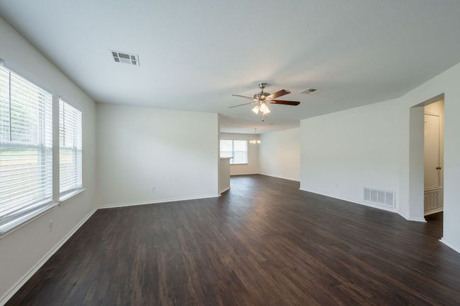 Unfurnished room with dark wood finished floors, a ceiling fan, and baseboards | Image 21