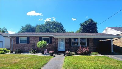 Brick ranch with level yard and carport | Image 1