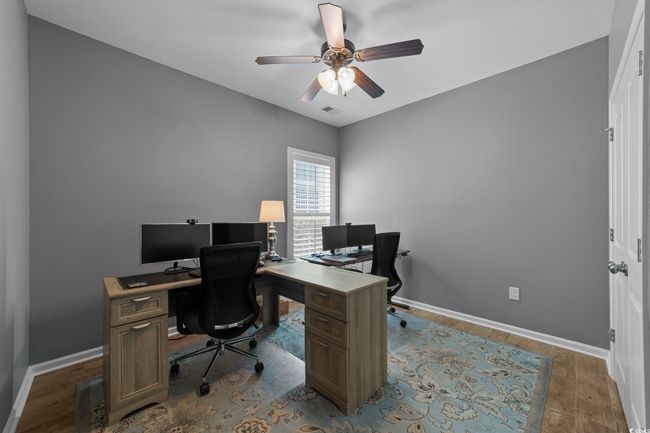 Office space featuring ceiling fan, baseboards, and wood finished floors | Image 27