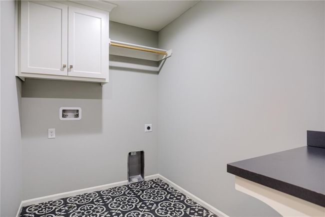 Laundry room with cabinets, tile floors, and electric dryer hookup | Image 37