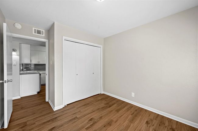 Unfurnished bedroom featuring wood finished floors and a closet | Image 5