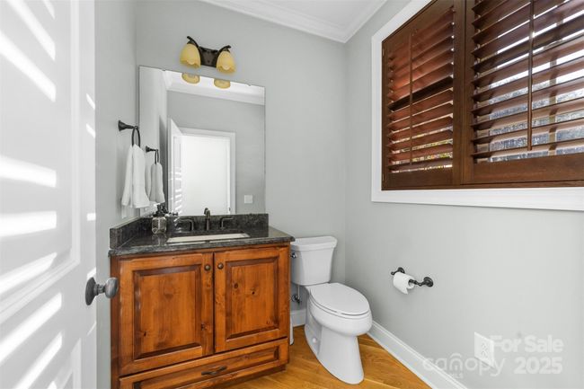Main level half bathroom just off the kitchen area. | Image 35