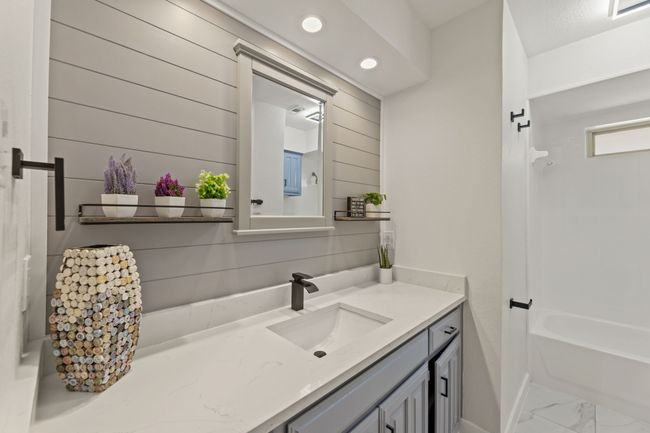 Bathroom featuring wood walls, marble finish floor, recessed lighting, vanity, and shower / bath combination | Image 21