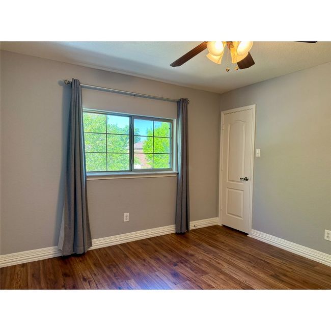 Bedroom number three on the upper level has ceiling fan and walk-in closet | Image 33