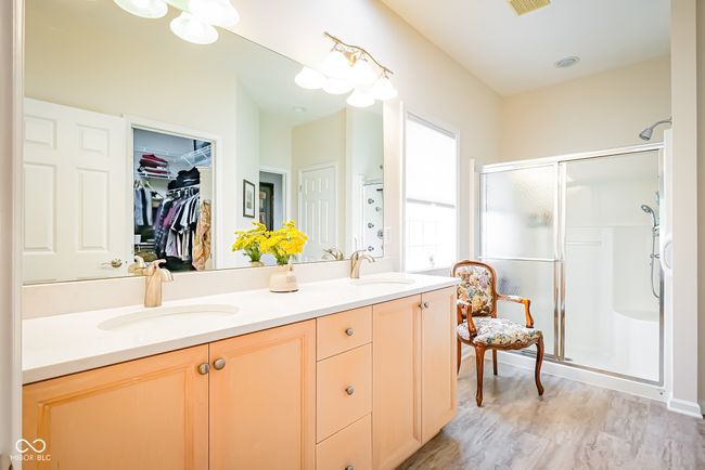 full bath featuring a shower stall, double vanity, and a walk in closet | Image 17