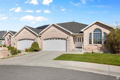 Ranch-style home featuring a garage and a front lawn | Image 1