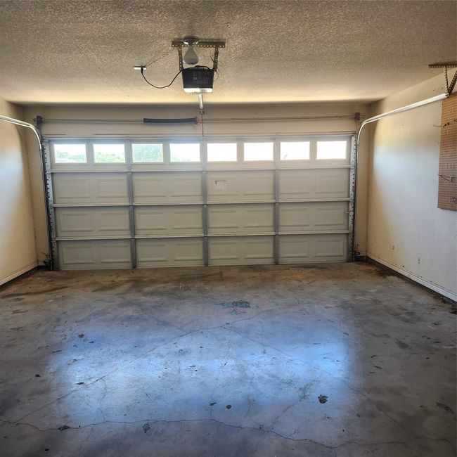 Large garage with plenty of room for tools storage and a small freezer | Image 22