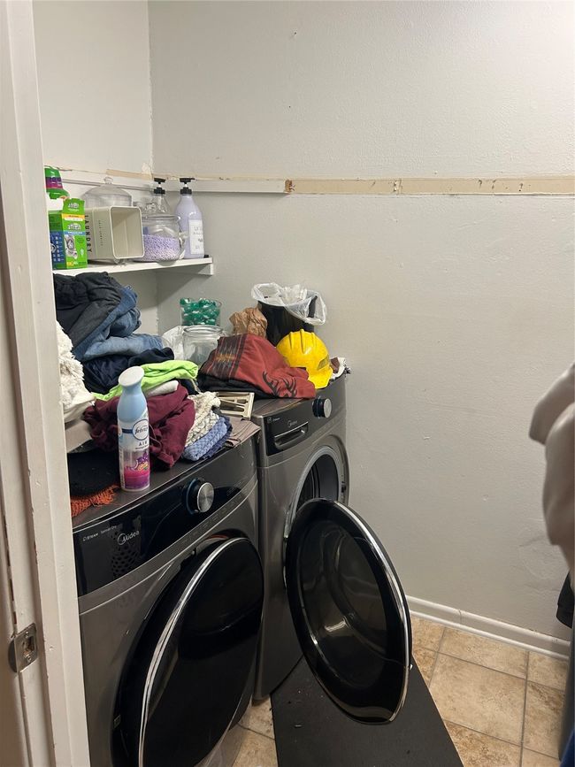 Laundry room featuring independent washer and dryer in the primary bedroom | Image 7