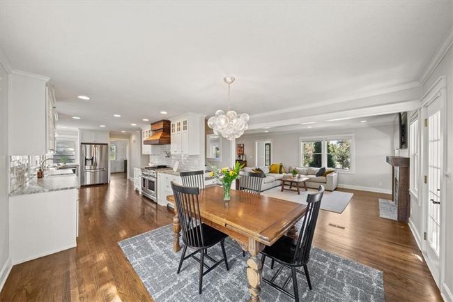 Dining room featuring baseboards, an inviting chandelier, recessed lighting, ornamental molding, and dark wood finished floors | Image 7