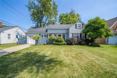 View of front of property with a front yard and a garage | Image 1