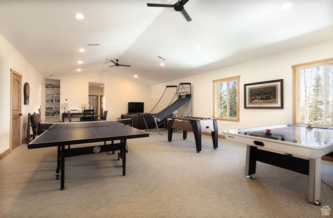 Game room with lofted ceiling, recessed lighting, a ceiling fan, and light colored carpet | Image 35