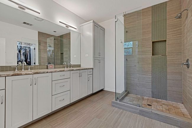 Full bath with a stall shower, double vanity, and a spacious closet | Image 14