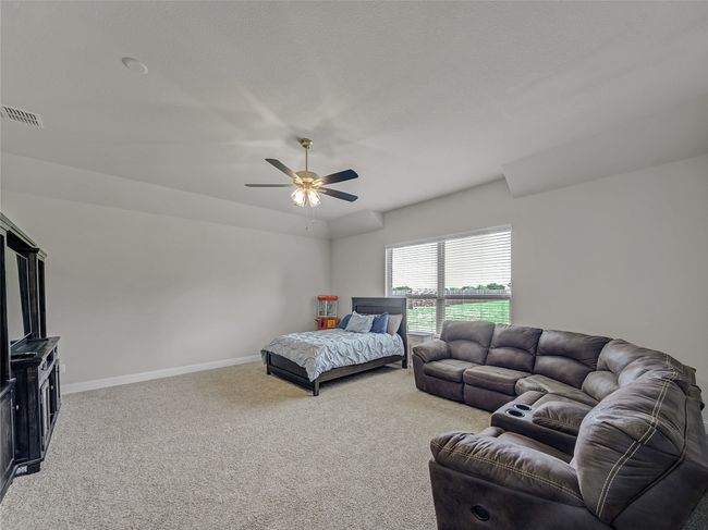 Bedroom with light colored carpet and ceiling fan | Image 33