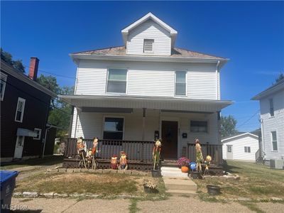 View of front of home with central AC unit and a porch | Image 1