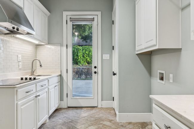Great utility room, full sized W/D, room for extra freezer/fridge, electric cooktop, sink, and plenty of cabinet space | Image 34