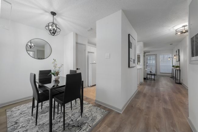 Dining area featuring a textured ceiling, light wood finished floors, baseboards, and a notable​​‌​​​​‌​​‌‌​‌‌​​​‌‌​​‌‌​‌​​​​​‌ chandelier | Image 15
