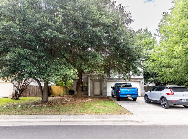 Obstructed view of property featuring driveway and an attached garage | Image 29