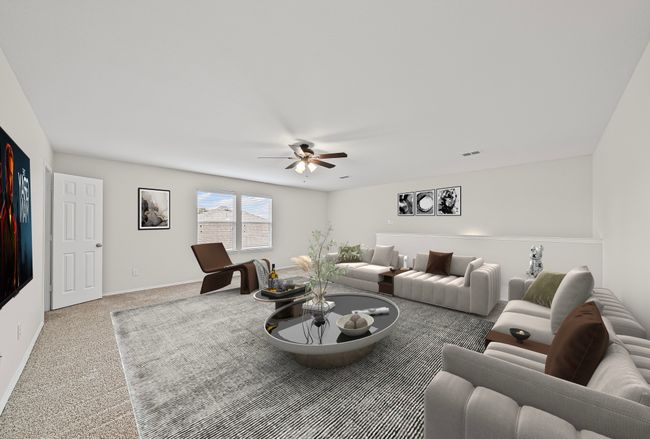 Carpeted living room featuring a ceiling fan and baseboards | Image 25