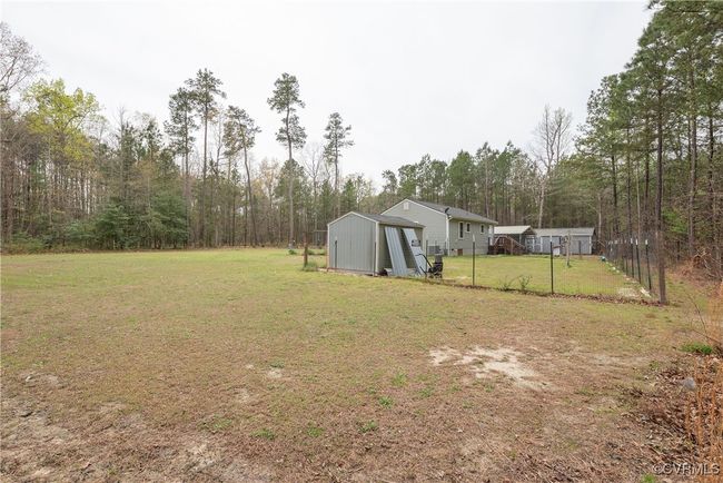 View of yard with an outbuilding, a storage unit, and fence | Image 40