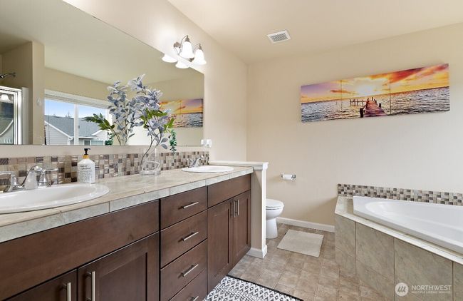 Private ensuite bathroom with soaking tub, step-in shower, dual sink vanity and plenty of counter space. | Image 21