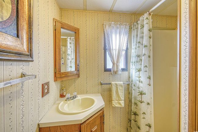 Bathroom featuring vanity and a shower with shower curtain | Image 8