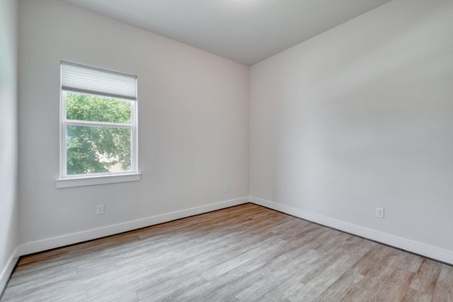 Empty room with wood finished floors and baseboards | Image 24