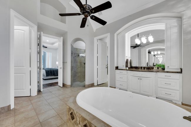 Primary bathroom with separate vanities and garden tub | Image 24