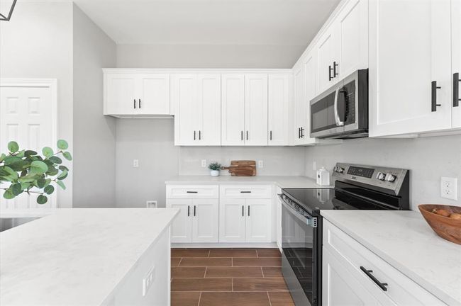 kitchen with Abundant cabinetry and prep space. | Image 11