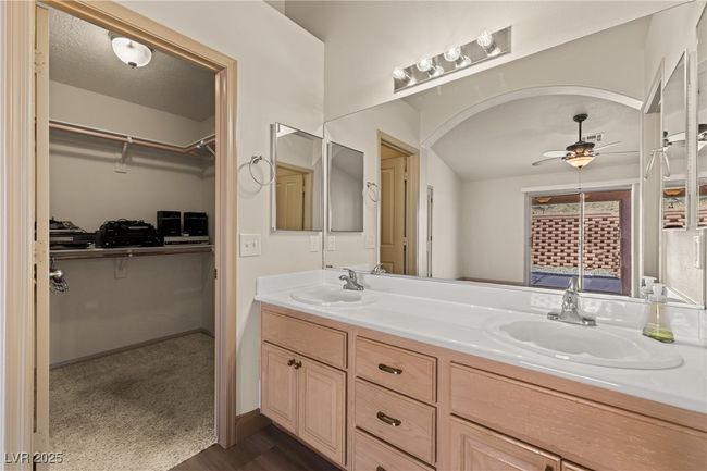 Full bathroom featuring double vanity, ceiling fan, wood finished floors, and a walk in closet | Image 34