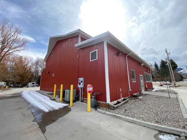 View of home's exterior featuring cooling unit and an outbuilding | Image 16
