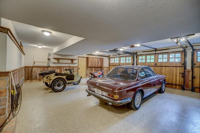Completely finished garage with in floor heat, epoxy floors and drains | Image 56