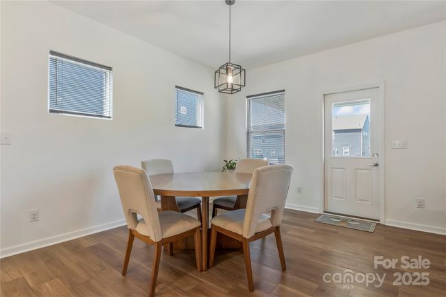 Eat-in kitchen dining area. Sellers upgraded the light fixtures throughout the home. | Image 9