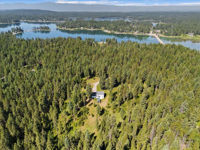Aerial overview of property's location featuring a heavily wooded area and a water and mountain view | Image 53