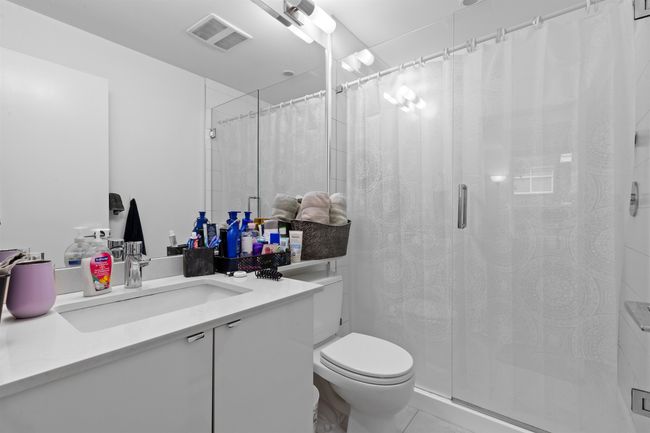 Bathroom featuring vanity, a shower with curtain, and tile patterned flooring | Image 31