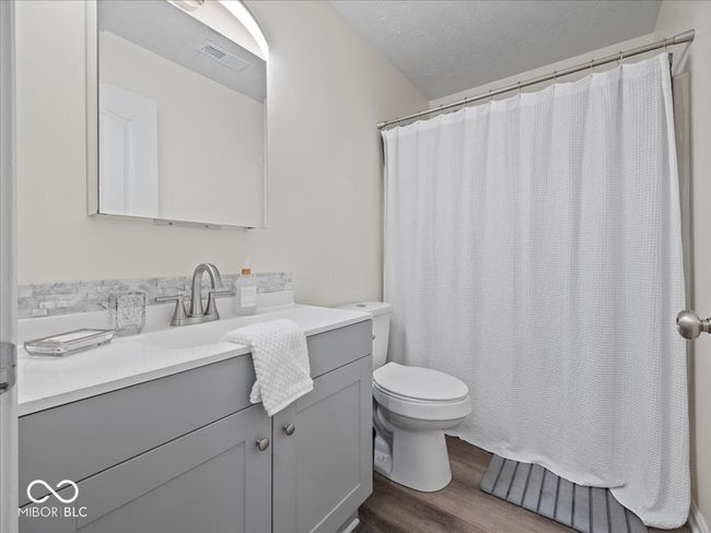 Hall full bath with shower/tub, hardwood floors, and vanity | Image 16