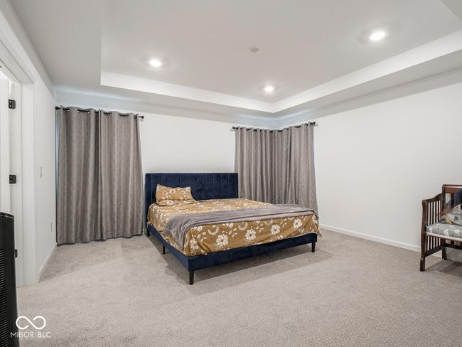 bedroom with a raised ceiling, baseboards, carpet, and recessed lighting | Image 33