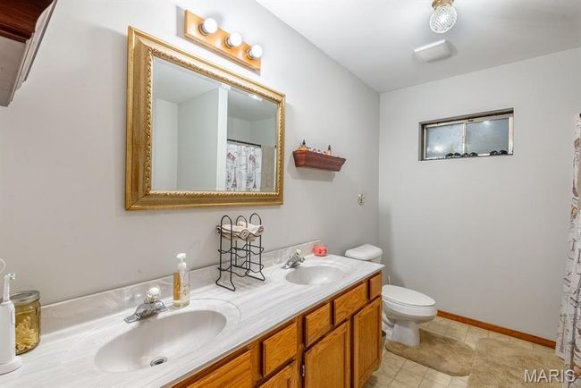 Bathroom featuring double vanity and tile patterned floors | Image 15