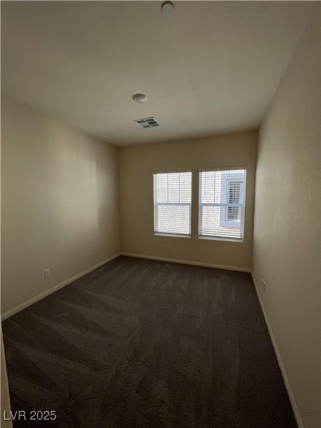 Empty room featuring dark carpet and baseboards | Image 24