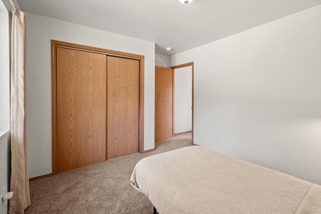 Bedroom with carpet flooring and a closet | Image 24