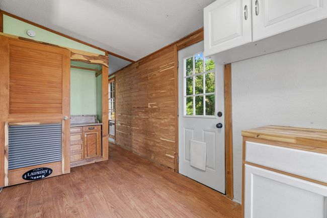 Doorway to outside featuring light wood finished floors and wooden​​‌​​​​‌​​‌‌​‌‌​​​‌‌​​‌‌​‌​​​​​‌ walls | Image 28