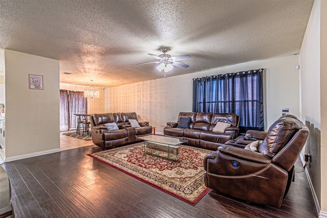 Living area featuring a chandelier | Image 4