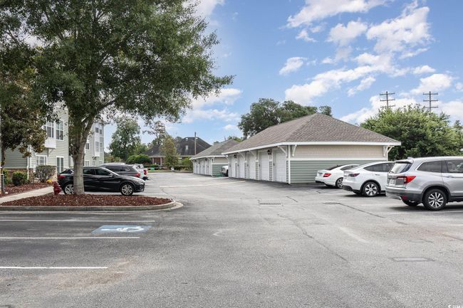Uncovered parking lot featuring community garages | Image 37