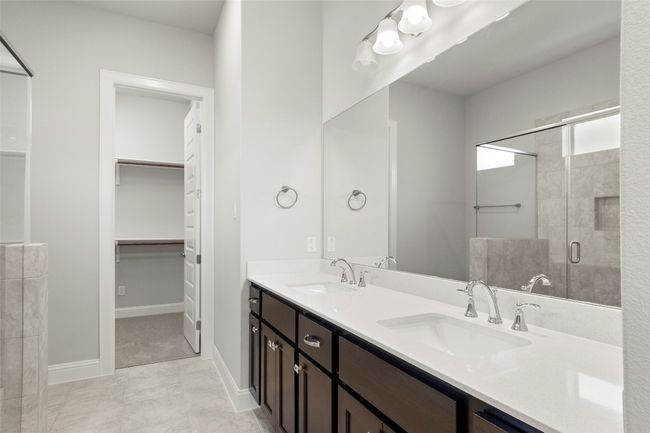 Full bath with a stall shower, double vanity, and a walk in closet | Image 27