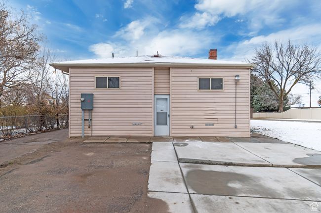 Back of house featuring a chimney, a patio, and fence | Image 26