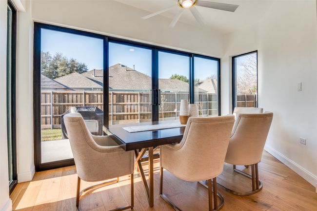 Dining room with baseboards, light wood-style floors, and a ceiling fan | Image 22