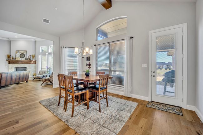 Dining space featuring a healthy amount of sunlight, a fireplace, and light hardwood / wood-style flooring | Image 8