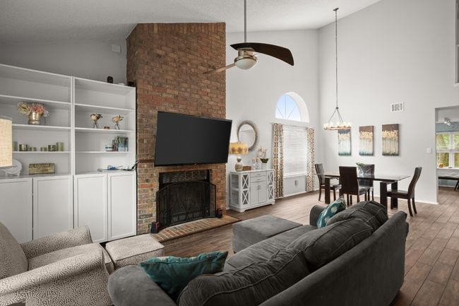 The living room is a breath of fresh air with its towering ceilings and oversized windows that flood the space with light, creating a truly open and airy vibe | Image 4