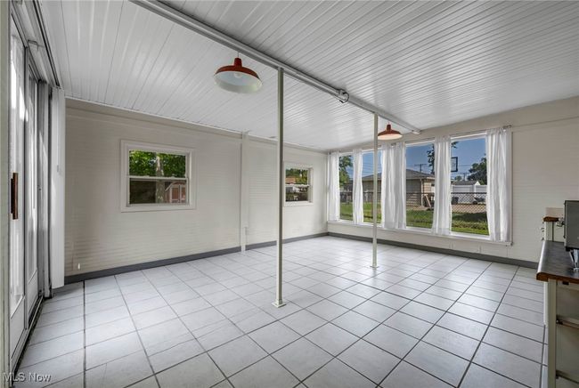 Unfurnished sunroom with tile patterned flooring | Image 35