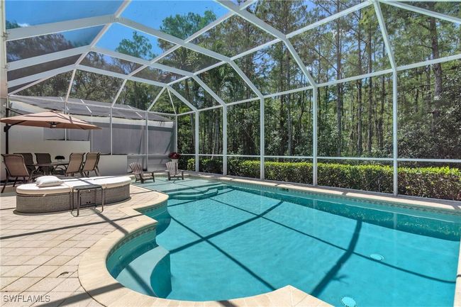 Outdoor pool featuring a patio area and a lanai | Image 25