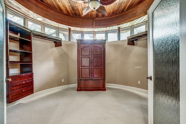Unique primary closet with cedar ceiling | Image 23